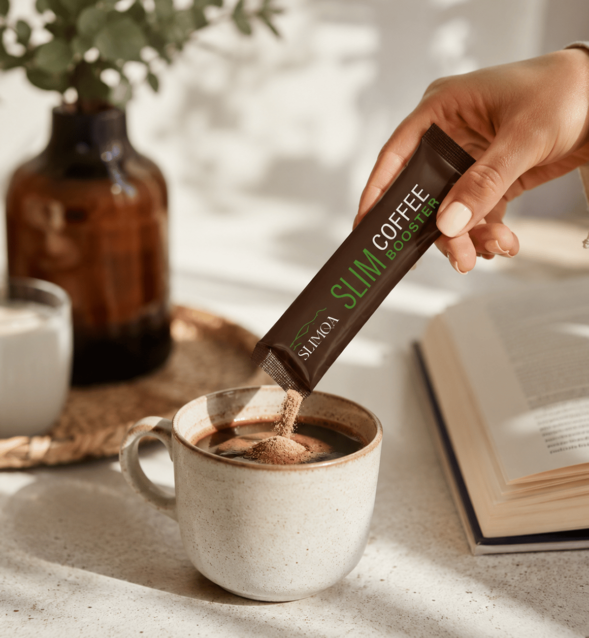 Hand pouring a Slimqa Slim Coffee Booster sachet into a cup of black coffee